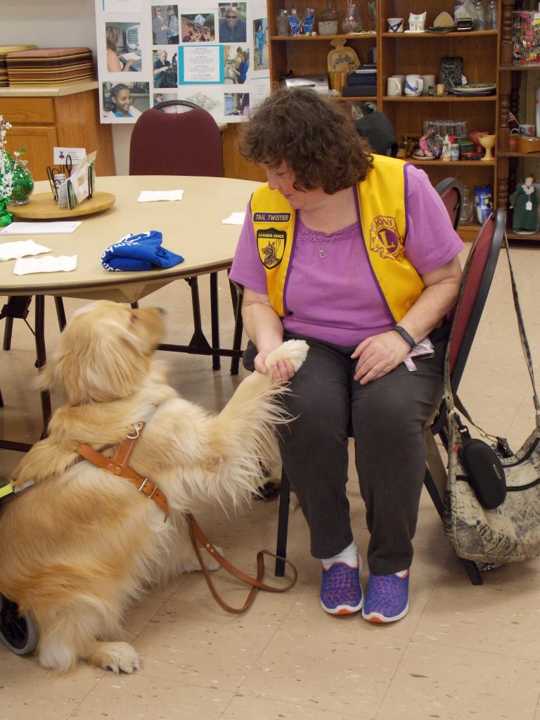 Leader DOg Jemma shakes hands